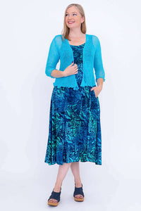 Model with light blue shrug over Shauna midi dress, Lagoon print