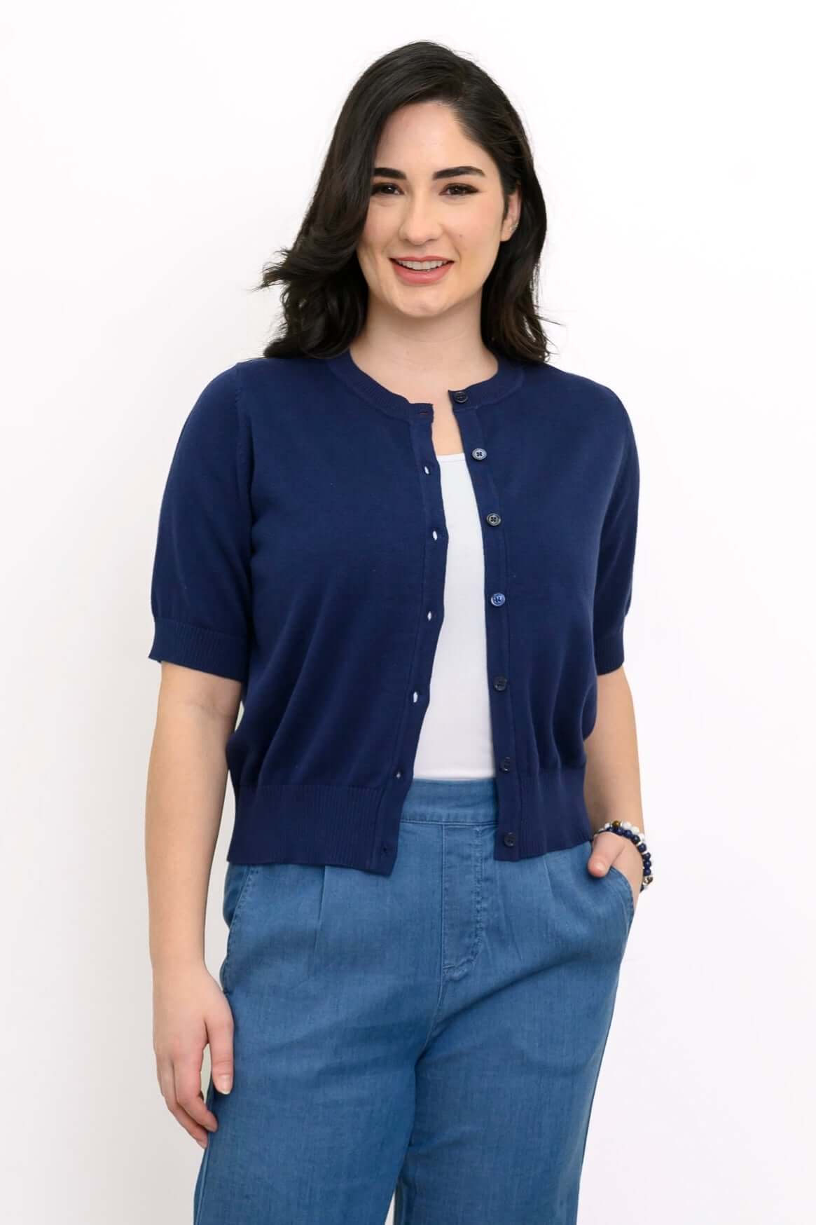 Woman wearing short sleeve indigo cardigan with blue pants, front view
