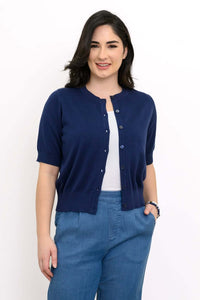 Woman wearing short sleeve indigo cardigan with blue pants, front view