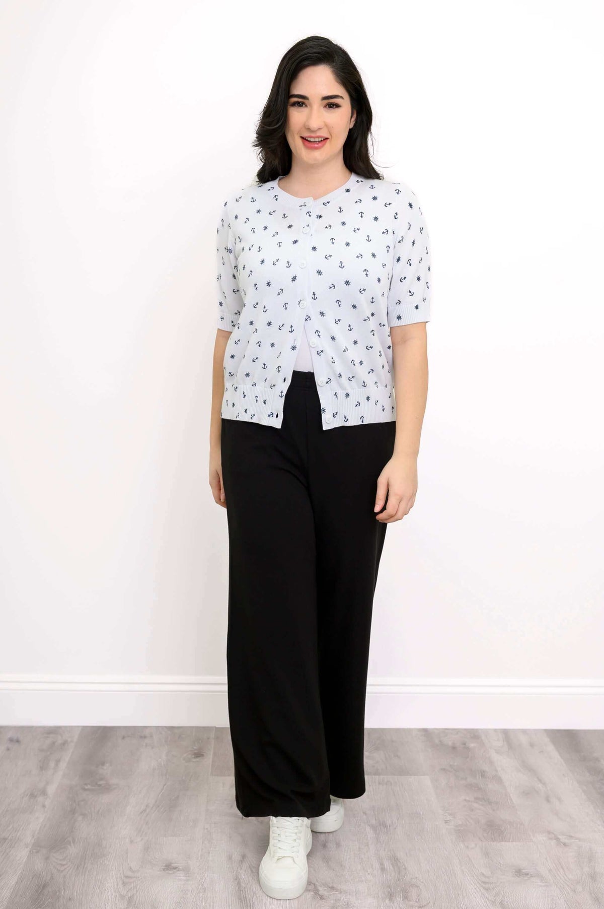 Woman in Shen nautical print short sleeve cardigan and black pants facing forward