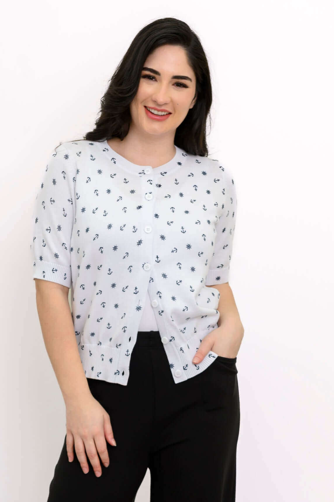 Woman smiling in Shen nautical print short sleeve cardigan and black pants