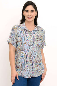 Woman wearing a short sleeve paisley print blouse with collar and dolman sleeves