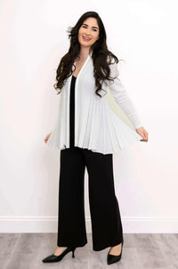 Woman displaying the flared pleats of the white Karen Cardigan