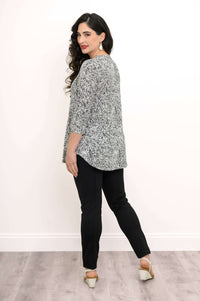 Side-back view of woman wearing black and white rose print bamboo top