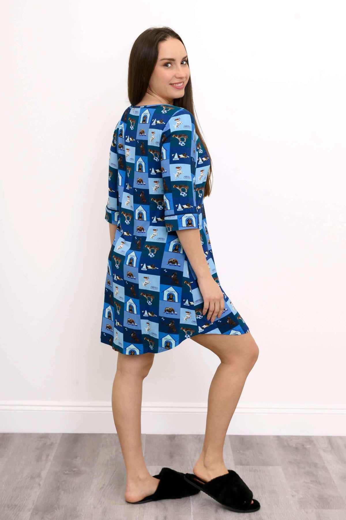 Woman showing side and back of blue dog print bamboo sleepshirt