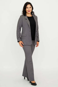 Side angle of a woman in checkered suit jacket and pants, wearing black heels