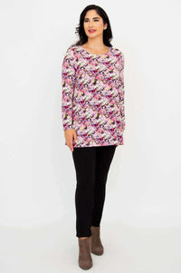 Side angle of floral tunic top styled with black pants and brown boots