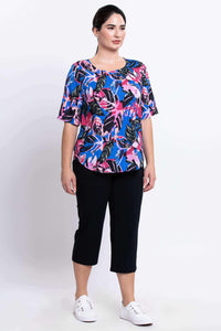 Side front view of woman modeling Liza tropical print tee blouse