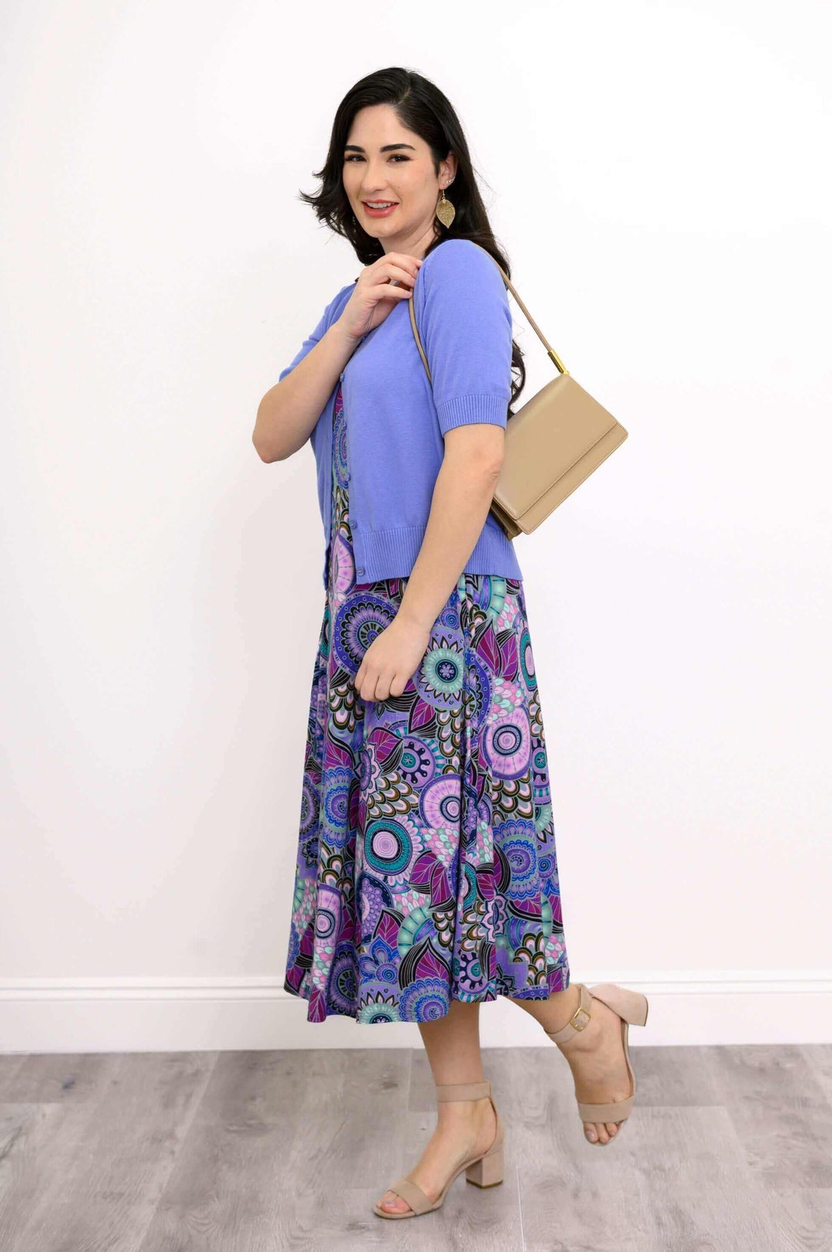 Side view of model with blue cardigan and beige bag over Evangelina tank dress