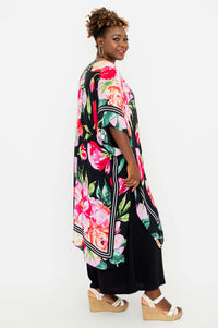 Side profile of model wearing the Darcy kimono wrap displaying side slit and floral design