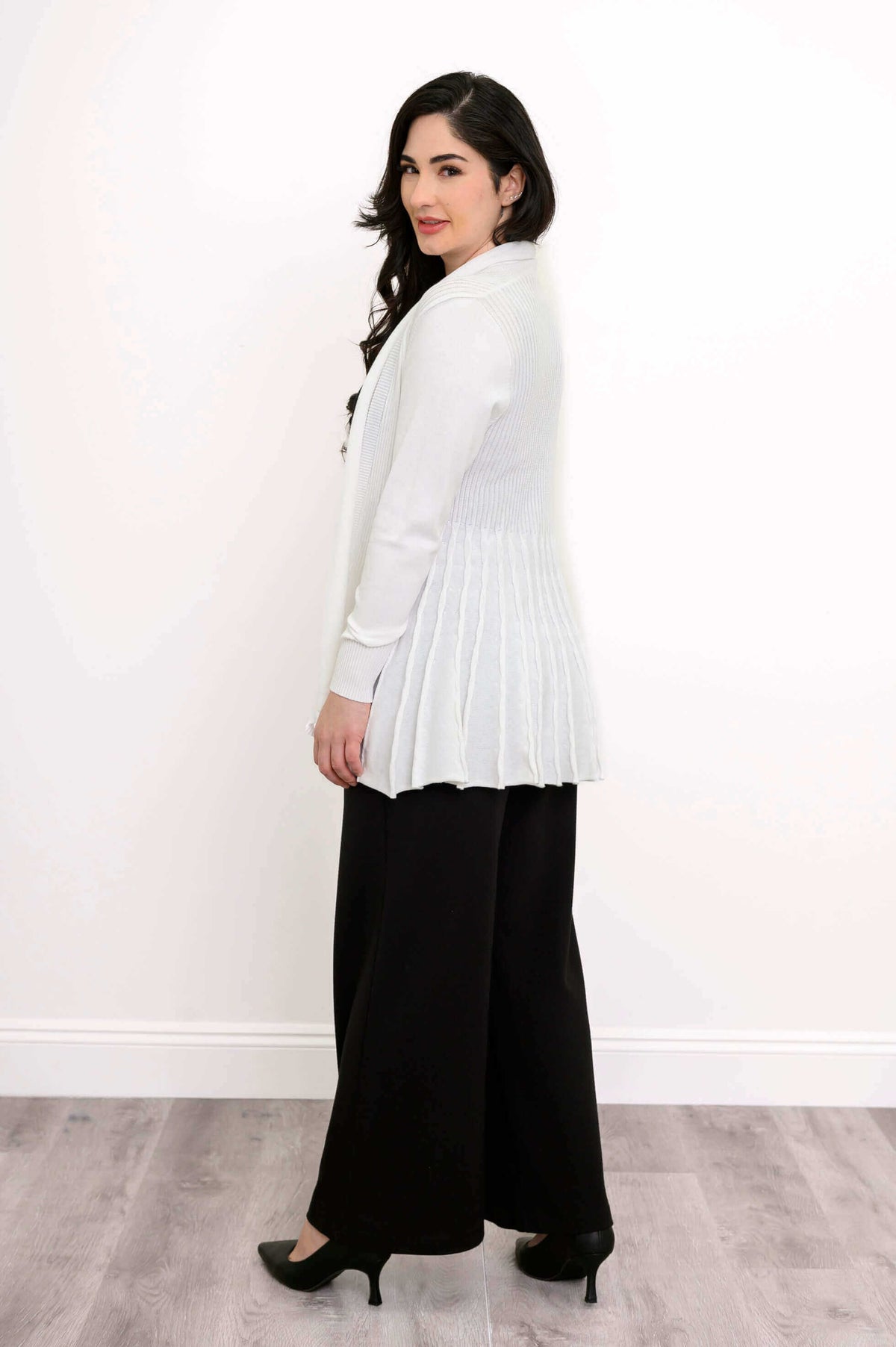 Side view showing the pleated back of the white Karen Cardigan