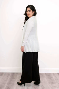 Side view showing the pleated back of the white Karen Cardigan