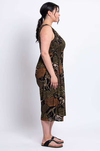 Side profile of model in a sleeveless wide-leg animal print jumpsuit and black sandals