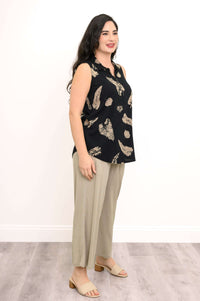 Side profile of model in sleeveless Hula zip tank and beige pants