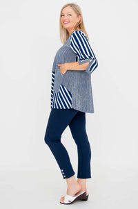 Side view of woman in navy and white striped blouse with hand in pocket, showing fit and sleeve detail