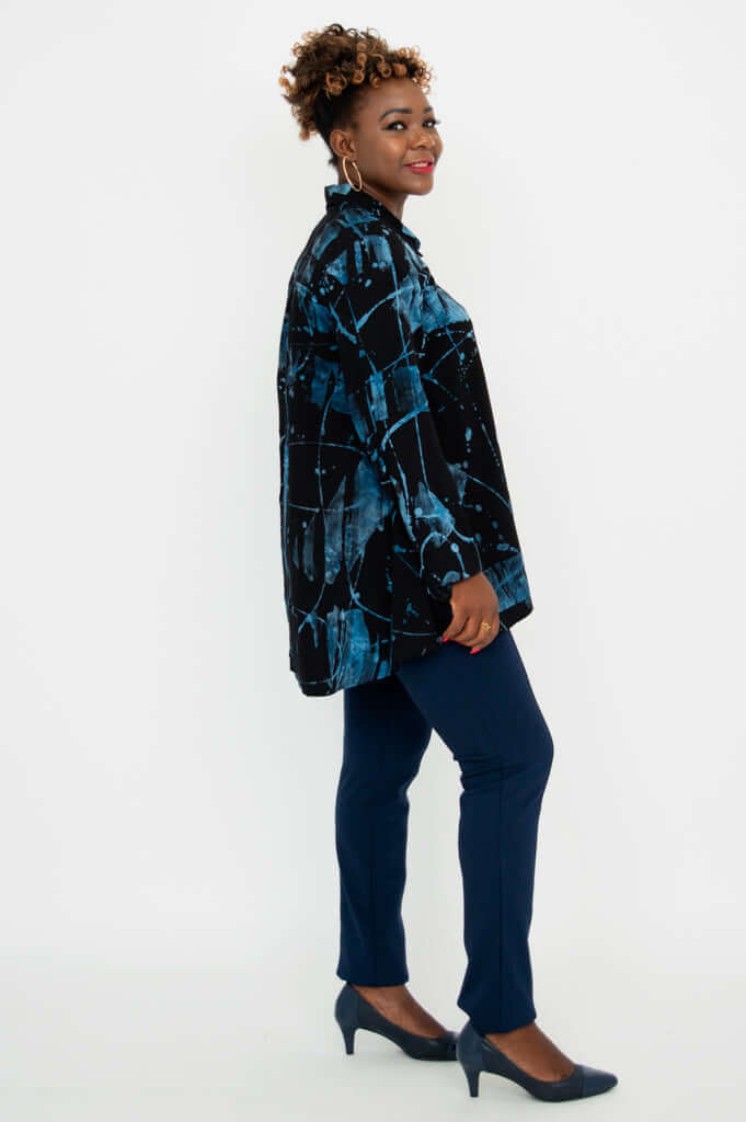 Side profile of woman wearing blue patterned Peruva top and navy pants