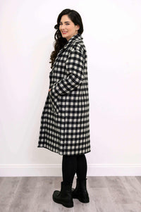 Side profile of a woman modeling a black and white check knee-length coat