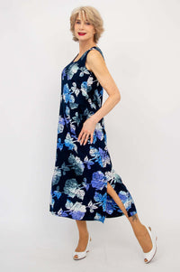Side view of woman in blue floral dress with slit, showing movement and pockets