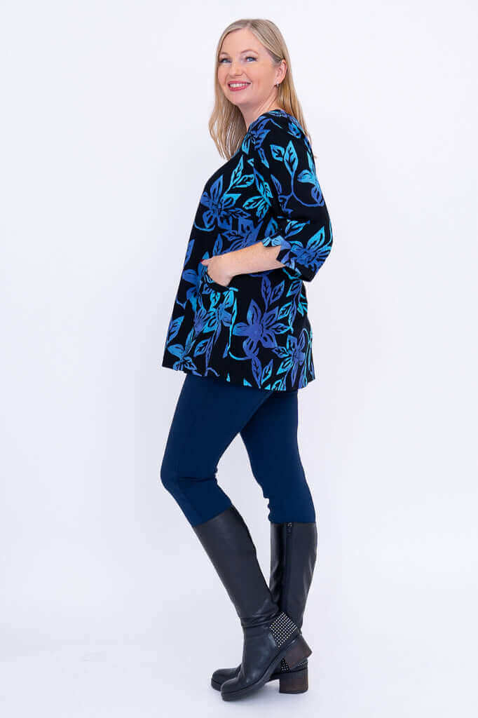 Side view of woman wearing the Evelyn Top with hands in pockets