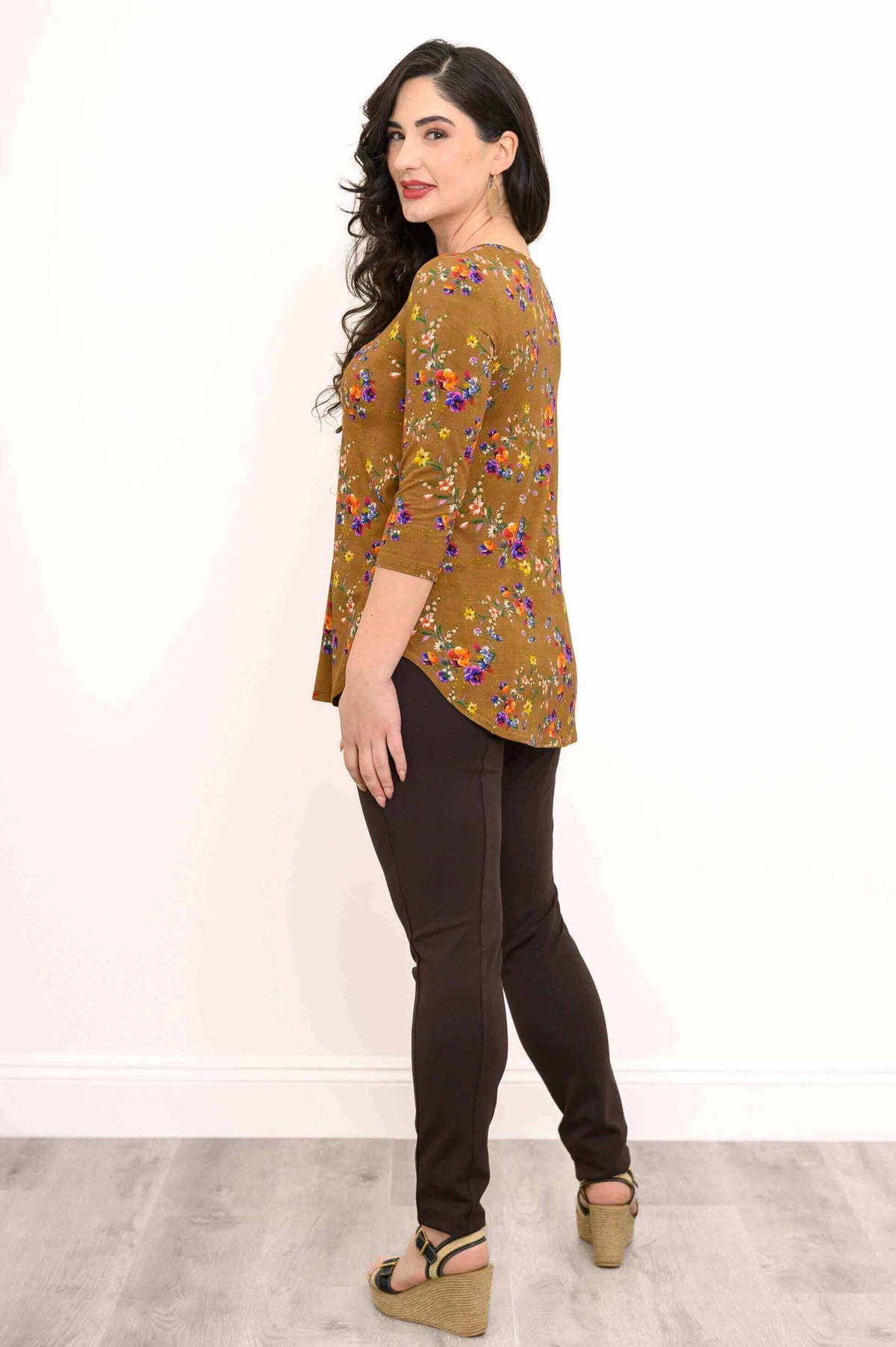 Side profile of model in Jackie Top featuring floral print and curved hem