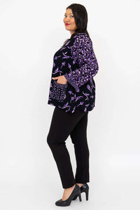Profile view of model wearing the black and purple floral print button top