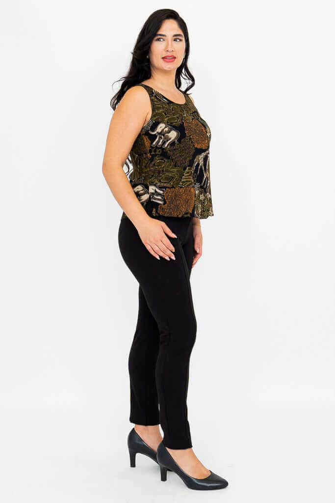 Side view of model in patterned sleeveless top and slim black pants