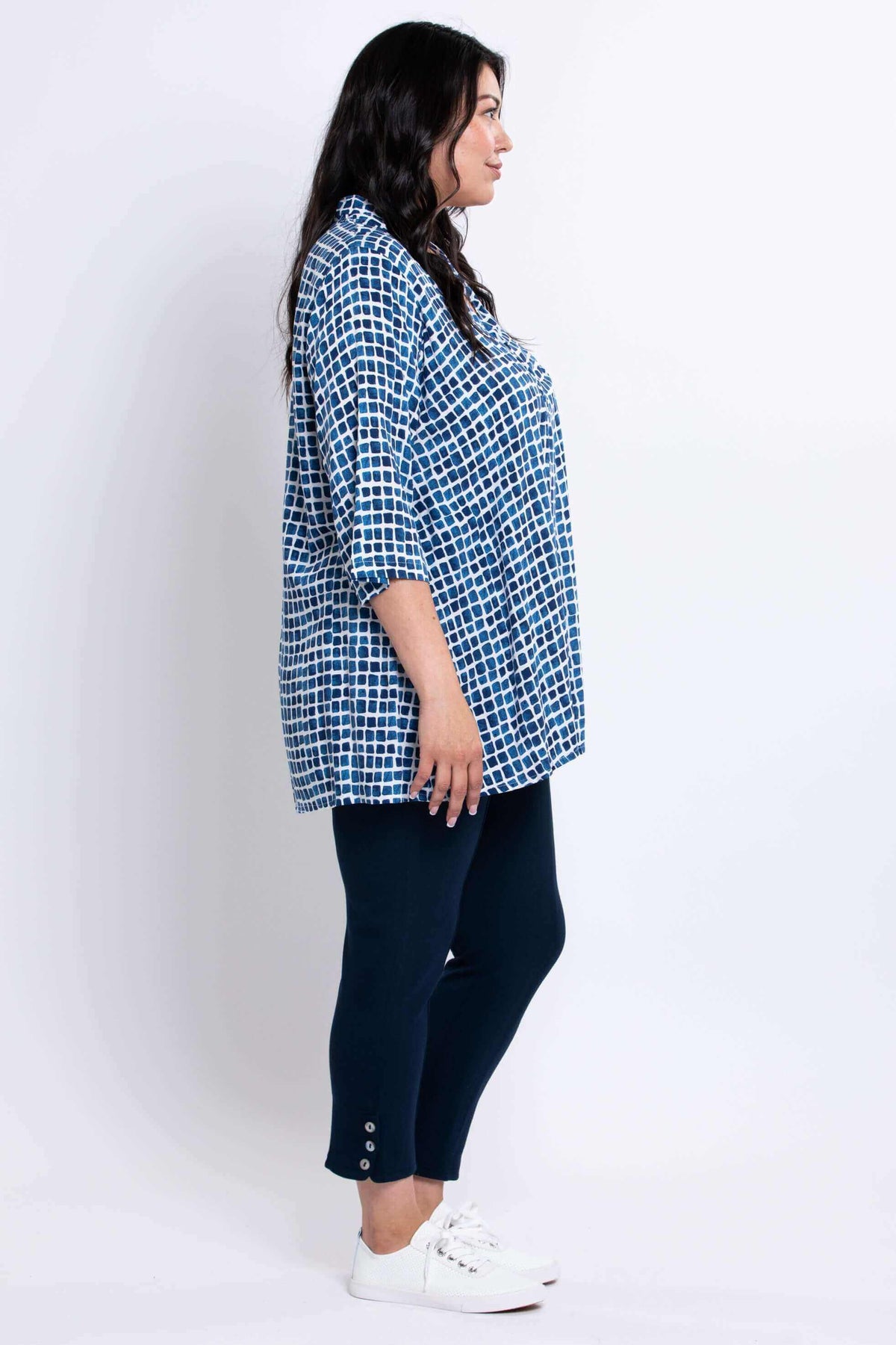 Side profile of model wearing blue batik print Shirley blouse
