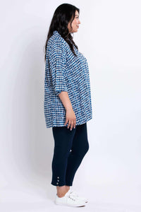 Side profile of model wearing blue batik print Shirley blouse