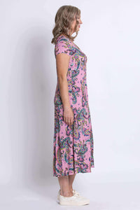 Side profile of woman in pink paisley midi dress