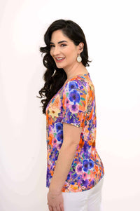 Side view of woman wearing colorful floral bamboo top