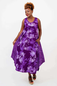 Woman showing side movement in purple floral midi tank dress