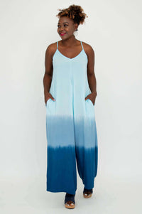 Model at an angle showing side view of blue ombre jumpsuit with pockets