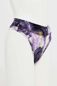 Side view of high-rise thong underwear in purple and gold abstract print on mannequin