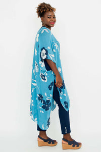 Side profile of a woman wearing a blue floral Darcy Kimono Wrap, smiling