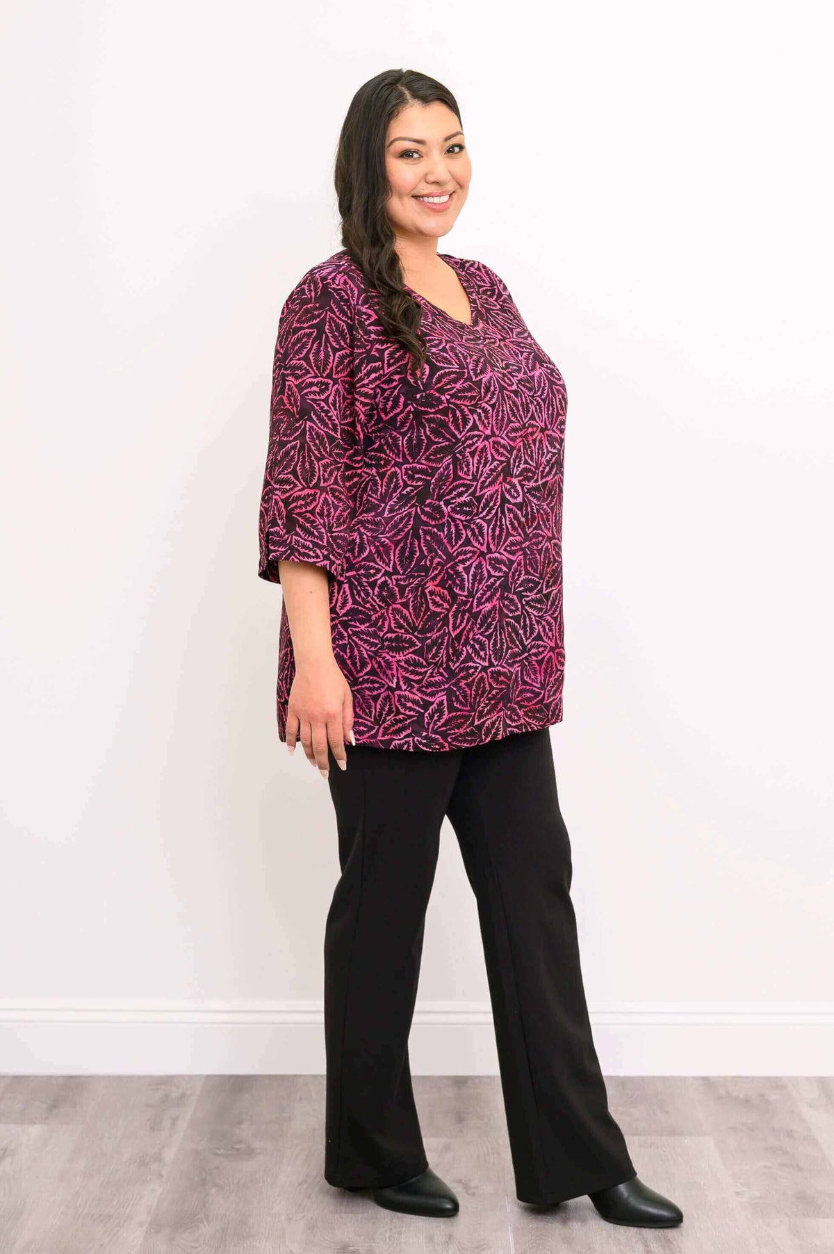 Side view of woman in Evelyn Top with pink leaf pattern and notched cuffs