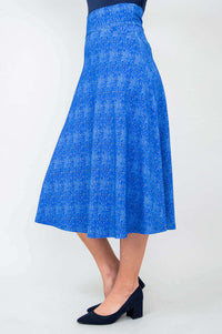 Side view of a woman modeling a blue bamboo blend skirt with a wide waistband