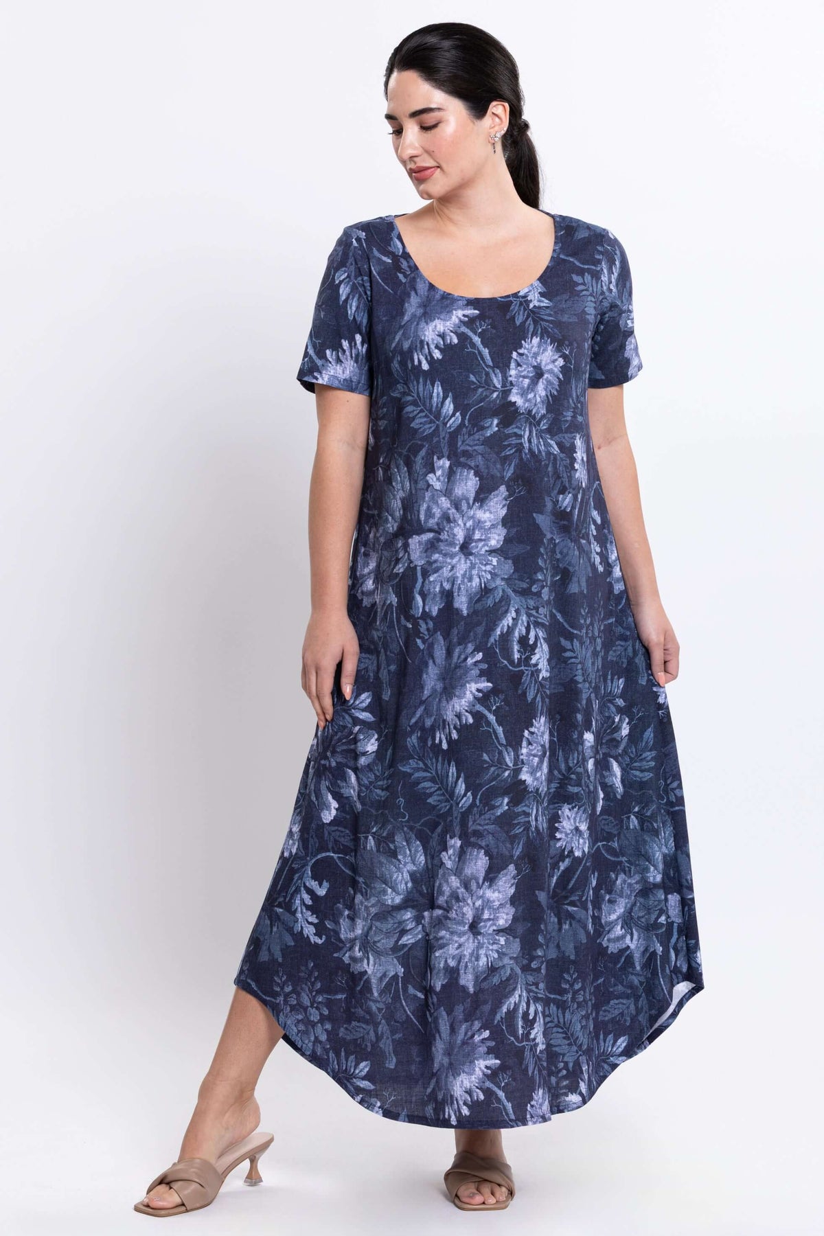 Model in Martha maxi dress with side view, highlighting flowy fabric and floral design