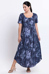 Model in Martha maxi dress with side view, highlighting flowy fabric and floral design