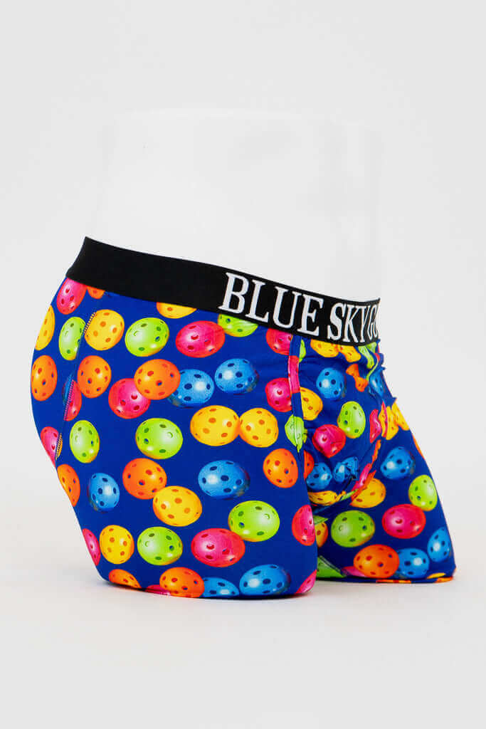 Side angle of men's boxer briefs featuring bright pickleball design and elastic waistband