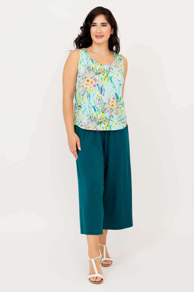 Side angle view of model in Ritzy Tank and teal pants, showing flowy fit