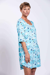 Side profile of woman in blue bamboo sleepshirt with scoop neckline
