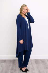Side view of a woman in a navy blue high-low duster cardigan over matching pants