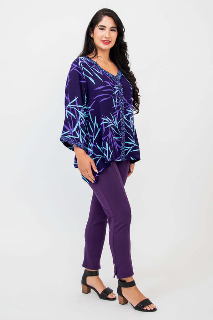 Side angle of purple bamboo print tunic top paired with purple pants and block heel sandals