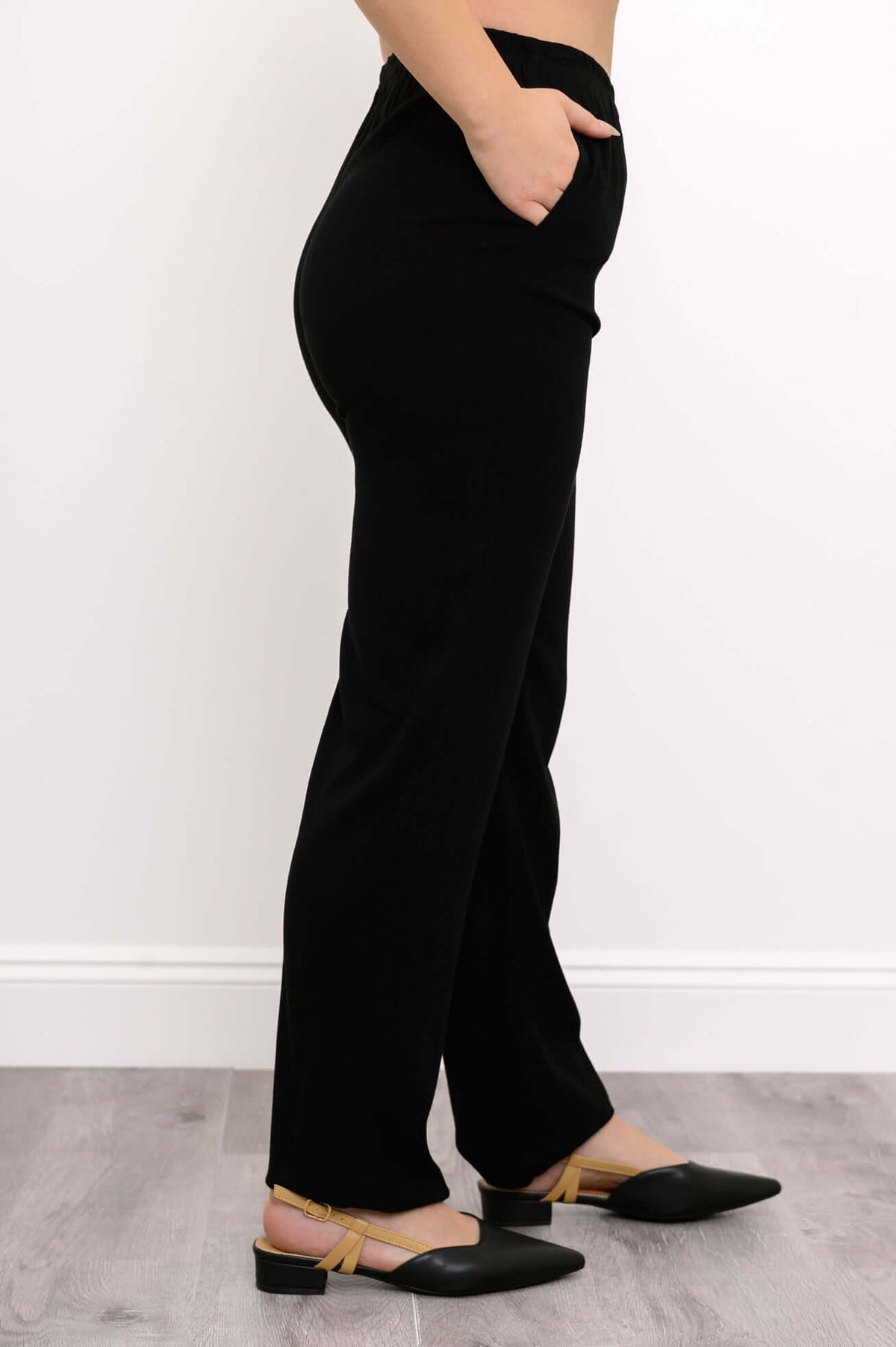 Side view of black bamboo-linen trousers showing relaxed fit and pockets