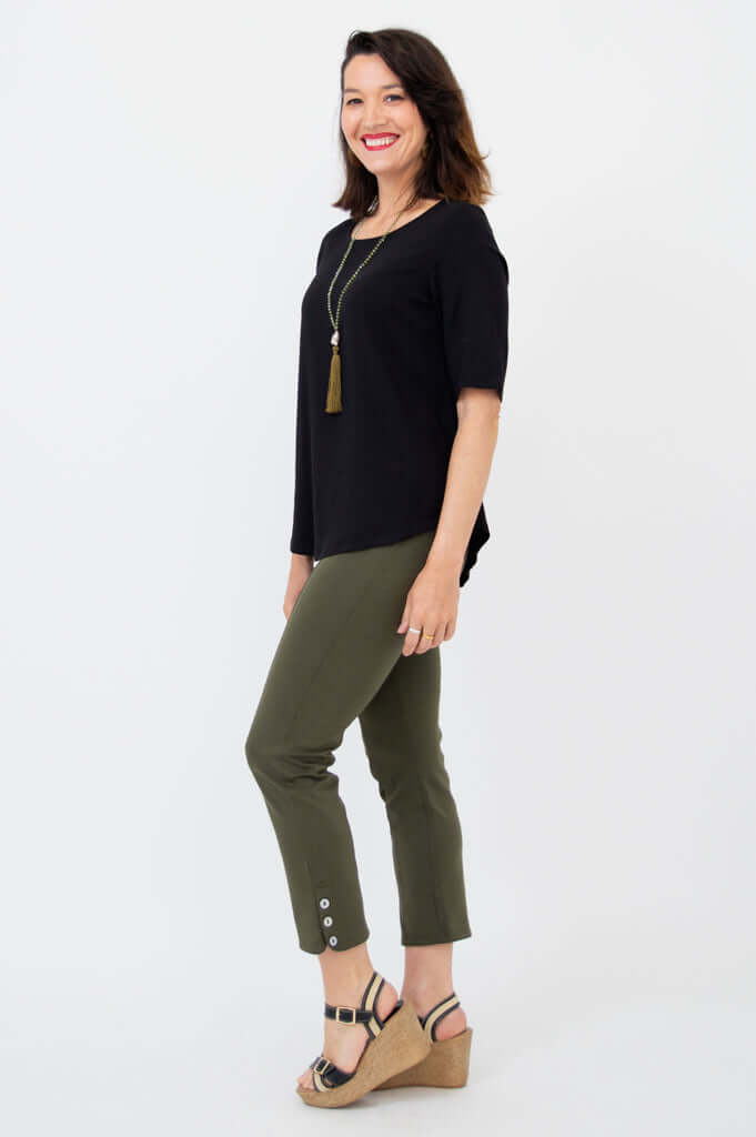 Side view of woman in black blouse and olive green pants
