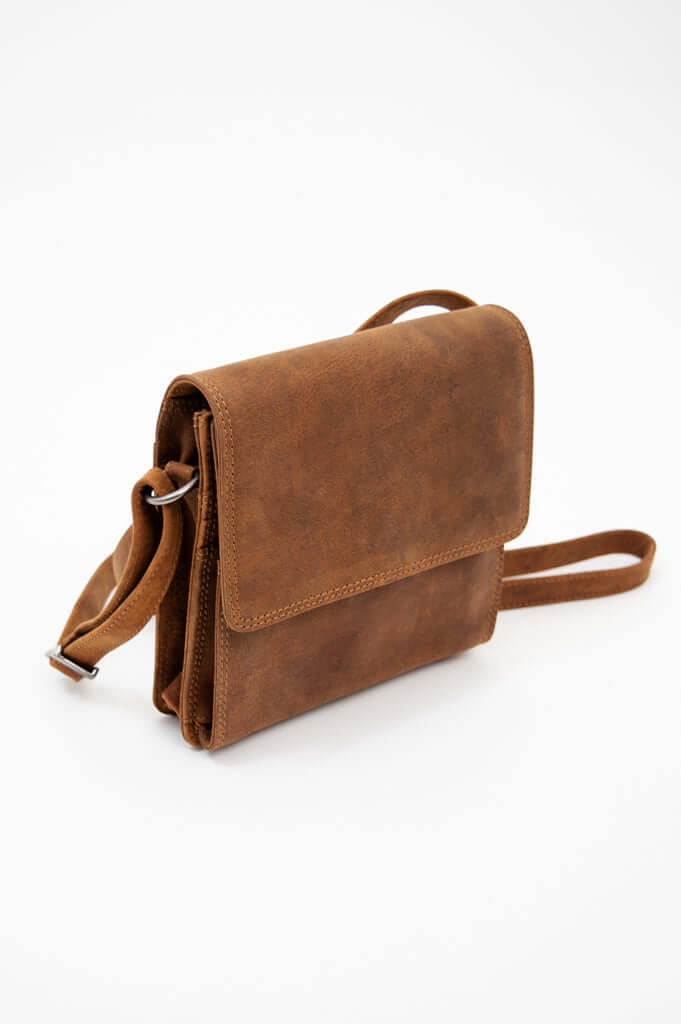 Side view of brown leather crossbody bag showing compartments and strap