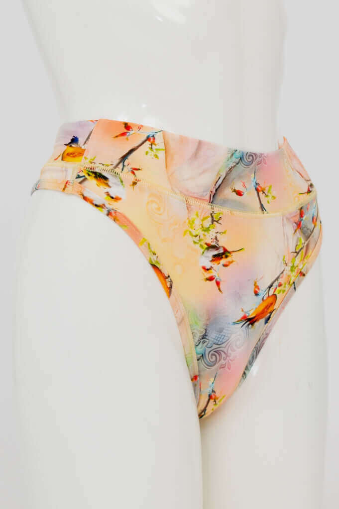 Side view of high-rise bamboo thong with colorful bird and branch pattern