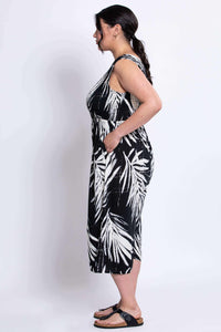 Side view of model in black and white jumpsuit with wide legs and pockets