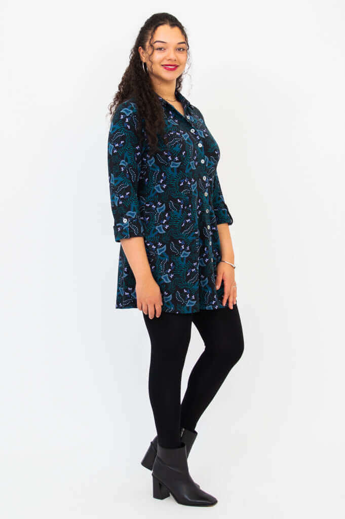 Side view of model in long bamboo shirt with patterned fabric and leggings