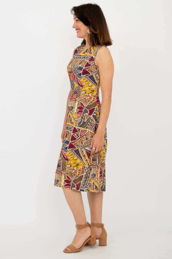 Side view of woman wearing sleeveless dress with colorful tribal patterns